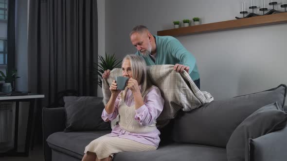 Elderly Grayhaired Man Covers His Wife with a Blanket Taking Care of Their Loved Ones Adult People