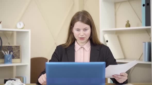 Smiling Young Caucasian Woman Agreeing with Someone in Wireless Chat and Talking