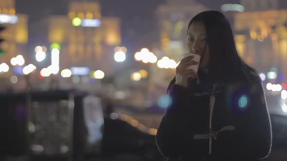 Asian Girl Drinking Tea and Relaxing After Hard Workday, Thinking About Life