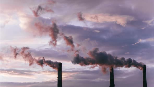 Smoke from large industrial pipes at dawn, environmental pollution. Time-lapse.