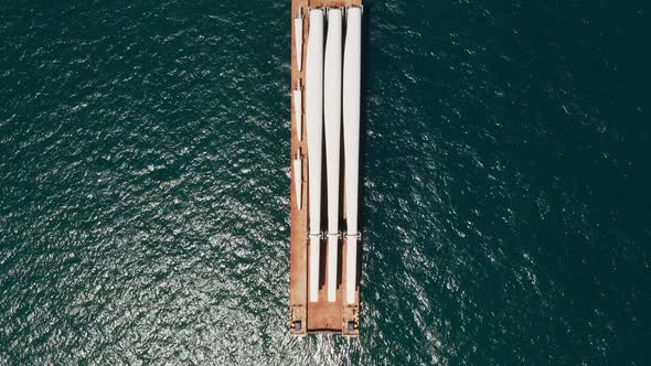 Heavy load carrier ship loaded with Electric Turbine Blades anchored at Sea.