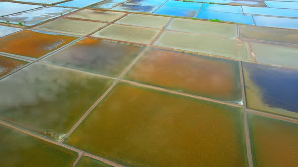 An aerial view from a drone flying over a salt fields, salt production.