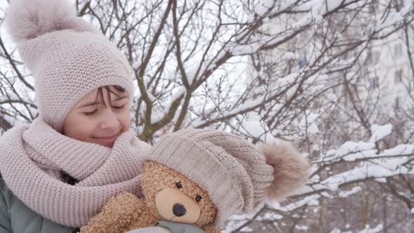 Child with Teddy Bear in Winter