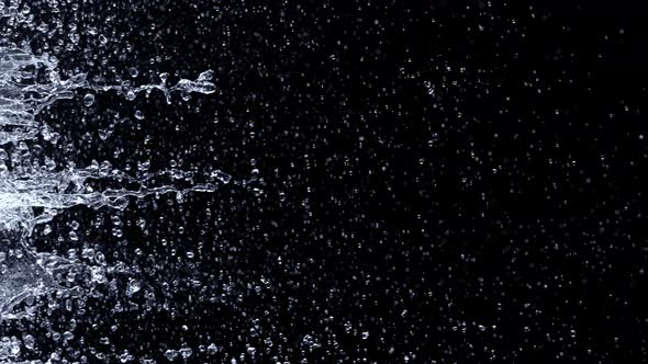 Super Slow Motion Shot of Water Side Splashes Isolated on Black Background at 1000Fps