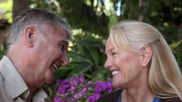 Man kissing wife on cheek