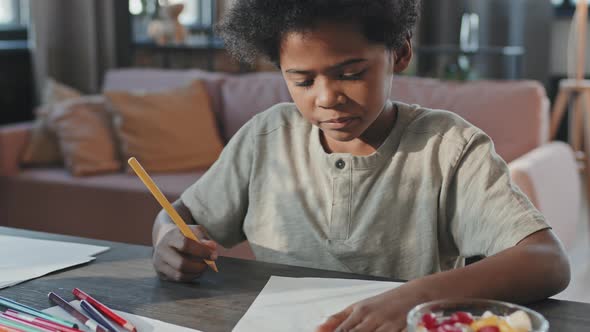 Black Boy Drawing at Home