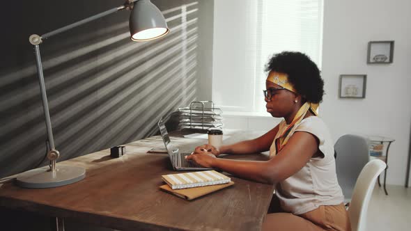 Afro-American Woman Working on Laptop in Office