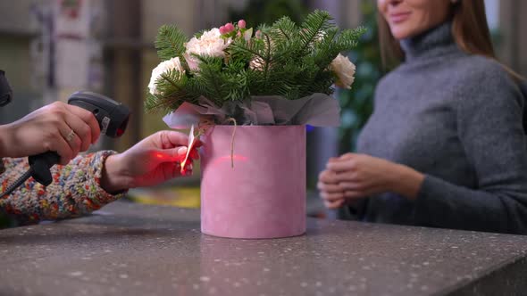Unrecognizable Seller Scanning Barcode on Bouquet and Buyer Walking Away in Slow Motion