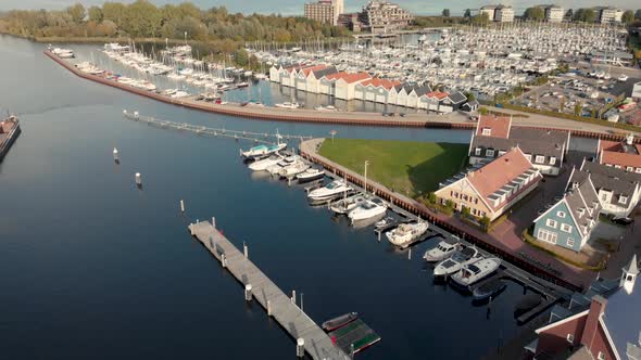 Aerial drone view of the port of Huizen panning up showing the wider surroundings with the Gooimeer