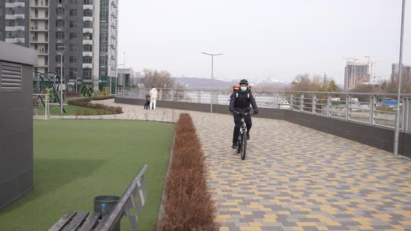 Masked Delivery Guy Riding Bicycle on Park Path