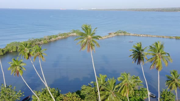 Fisherman on small boat at Soco river mouth, Dominican Republic. Aerial drone view