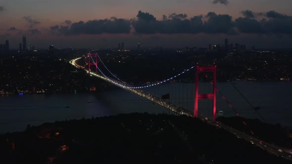 Wide Establishing Shot of Bosphorus Bridge Illumination in Red Light in Istanbul, Turkey, Aerial