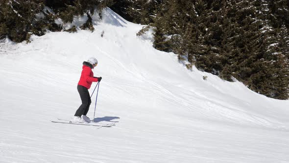 Skier Slides On Skis On Snowy Track At Ski Resort In Winter