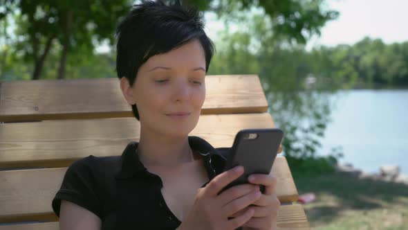 Women Face Closeup with Cellular Phone Texting.