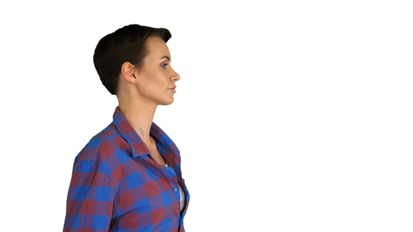 Short haircutted casual woman dancing on white background.