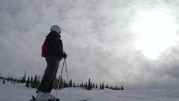 Skier Stand On Mountainside Enjoying Freedom And Relaxation Background Of Sunset