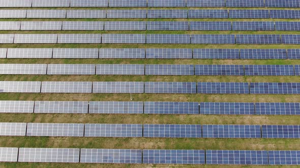 Flight Over the Solar Power Station Rows Panel Glide Moving Among the Cells