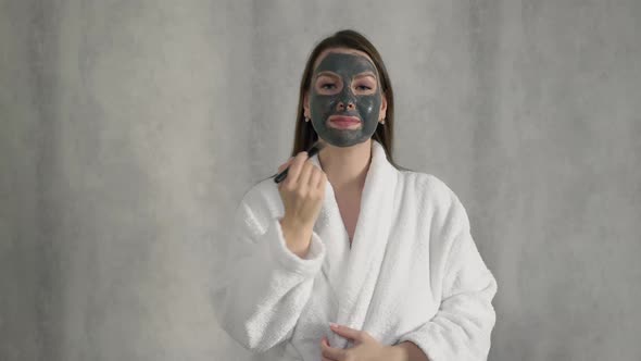 Young Woman Takes Care of Skin of Face