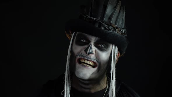 Man with Skeleton Makeup Trying To Scare, Opening His Mouth and Showing Dirty Black Teeth and Tongue