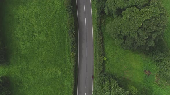 Filmed in Tenby in 2018, during the Ironman Triathlon.Cyclists along a road.