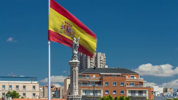 Spanish Flag Waves Behind Statue of Christopher Columbus Timelapse Plaza De Colon in Madrid Spain