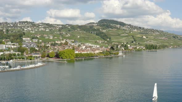 Flying towards town Lutry passing by sailboatSummer seasonLutry, Lavaux - Switzerland