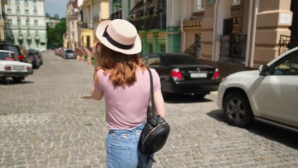 Beautiful Young Woman Tourist Pleasant Walk in the City Center