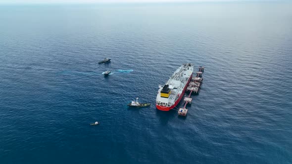 Tugs help the gas tanker to go to sea aerial view 4 K Turkey Alanya