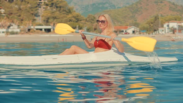 Paddling Canoe Adventure. Tourist Woman Spending Day Kayaking On Sea. Water Tourism Canoe.