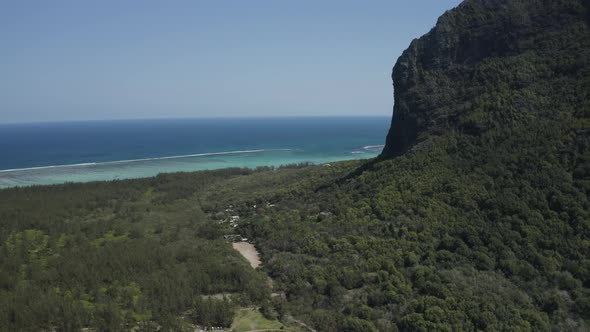 Aerial view of a person doing paragliding among the mountain, Mauritius.