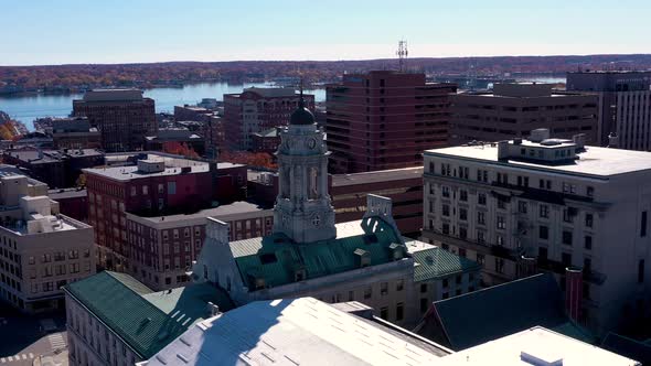 Drone orbiting City Hall in Portland Maine with the ocean in the background.