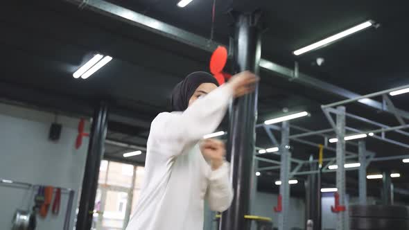 Young Muslim Woman Focused on Boxing a Woman Dressed in Sports Hijab Likes to Fight in the Gym