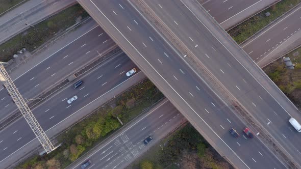 Vehicles Driving on a Motorway at Sunset Using Bridge Infrastructure