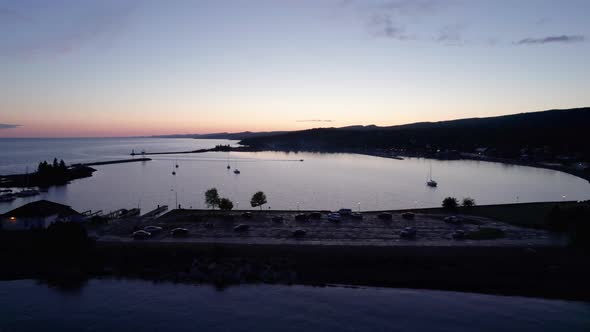 Drone shot of an active boat harbor during sunset in the summer