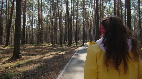 Girl runner runs in the park goes for sports. runner athlete girl running on trail nature.