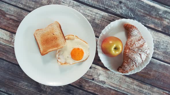 Healthy Tasty Breakfast: Fried Egg, Toast, Apple and Croissant