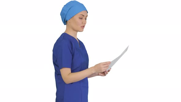 Female Professional Doctor or Nurse Reading Medical Form While Walking on White Background