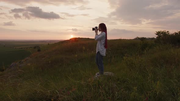 Side View of a Girl That Hold Her Camera