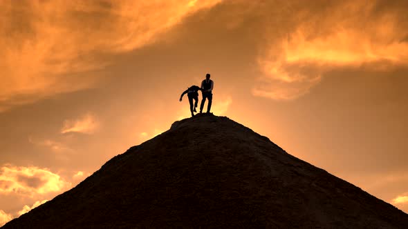 Silhouettes Help Each Other on Top of the Mountain