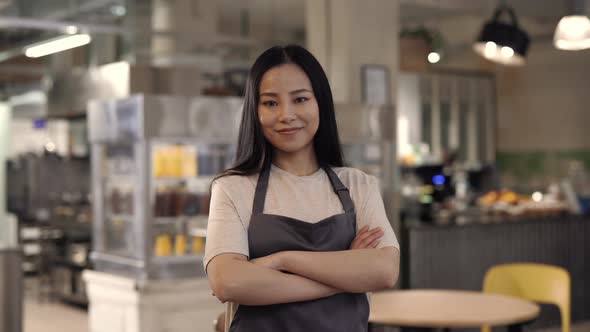 Female Employer Standing with Crossed Arms at Own Cafe