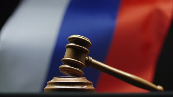 Judge's Wooden Hammer Against Russian Flag Waving. Gavel On Block In Russian Federation Court Room