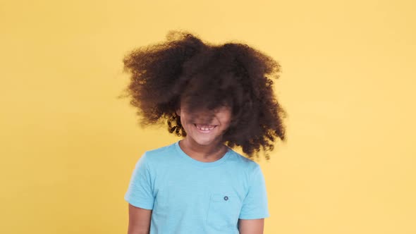 Happy African American Little Child Shaking Head on Yellow Background