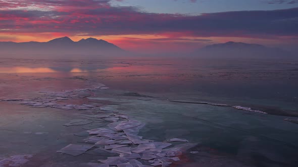 Panning over cracks in the ice durning sunrise over Utah Lake