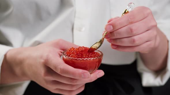 Chef Taking Red Caviar From Glass Bowl Closeup