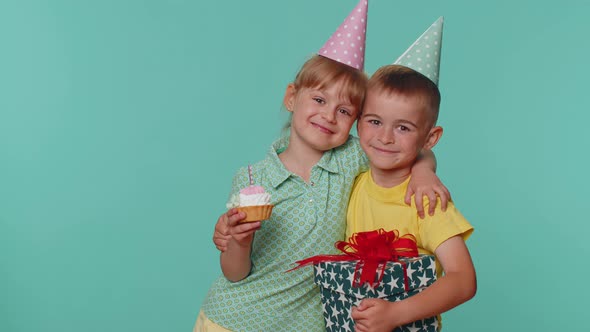 Happy Children Boy Girl Siblings Friends Celebrating Birthday Blowing Candle on Cake Making a Wish