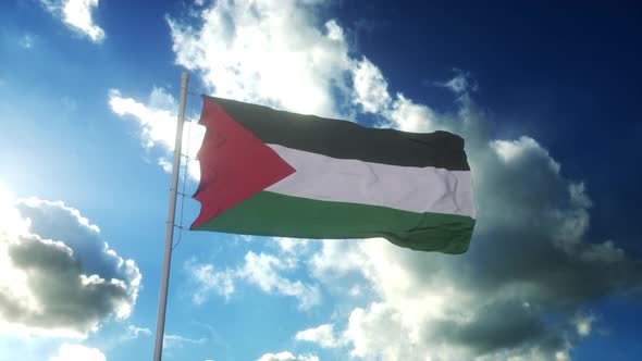 Flag of Palestine waving at wind against beautiful blue sky