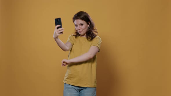 Portrait of Woman Using Smartphone to Take a Selfie Feeling Confident and Beautiful Striking