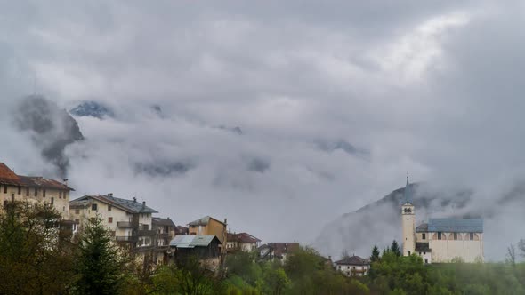 Clouds Move Over the Mountain Valley and Alpine Village