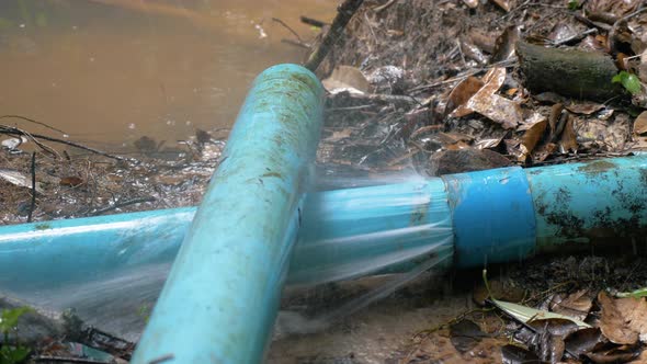 Broken or leaking Industrial pipe with water, water leakage from damaged rusty pipe, slow motion