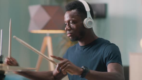 Black Guy Practicing to Play Drums